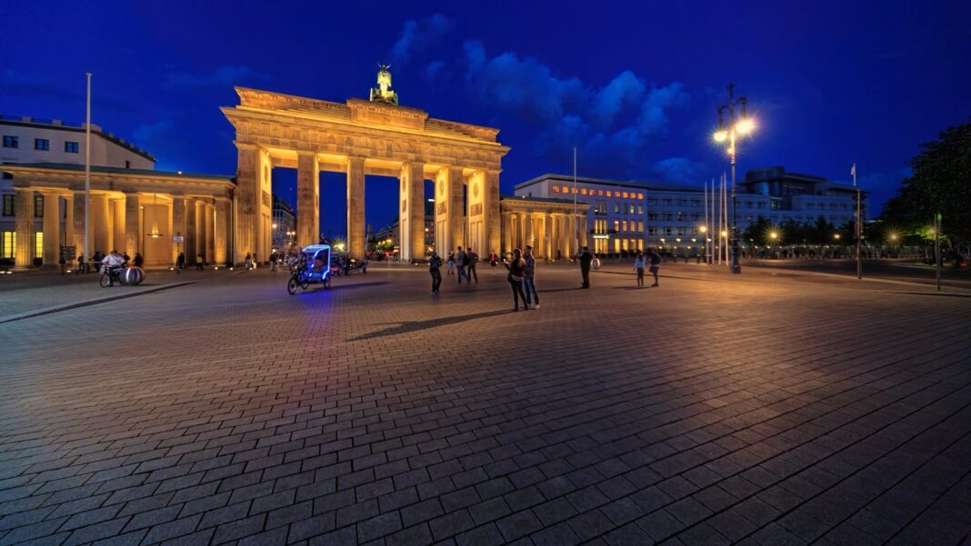 Stunning night view of Berlin's Brandenburg Gate lit up, showcasing its grandeur.